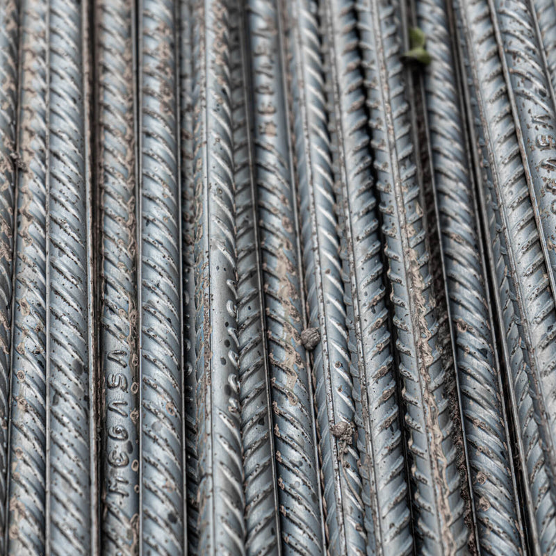 Close-up view of steel reinforcement bar texture, highlighting construction material detail.