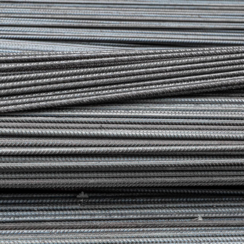 Piled of steel reinforcement bars, ready for deployment in structural projects.
