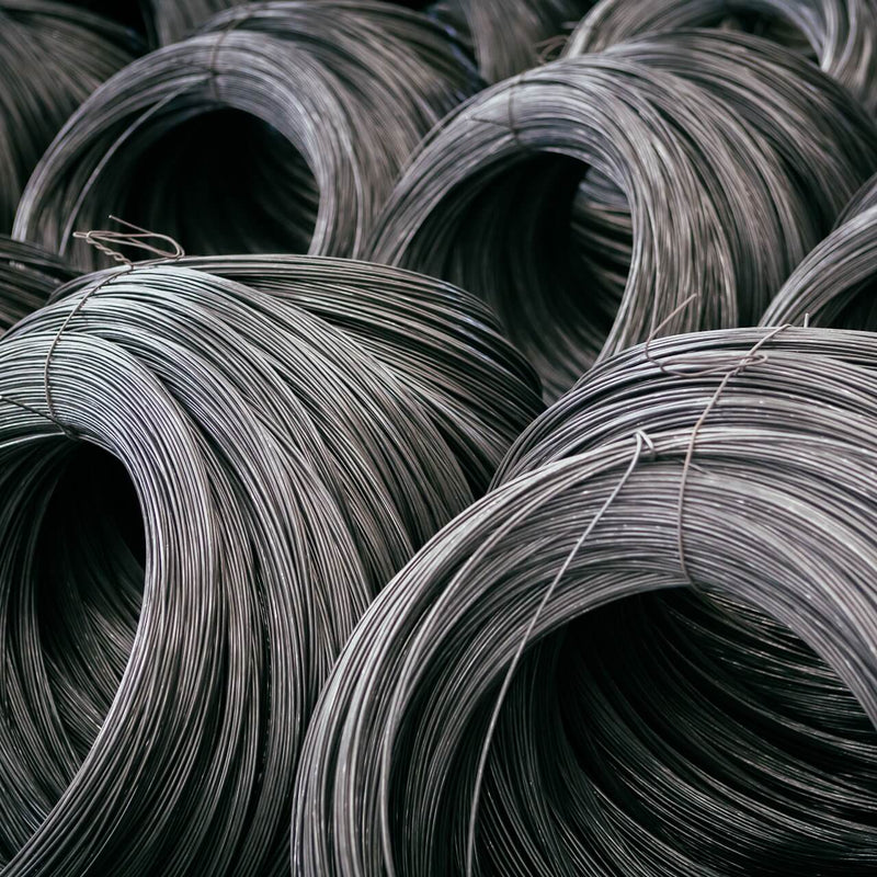 Stack of black annealed tying wire coils, ready for construction use