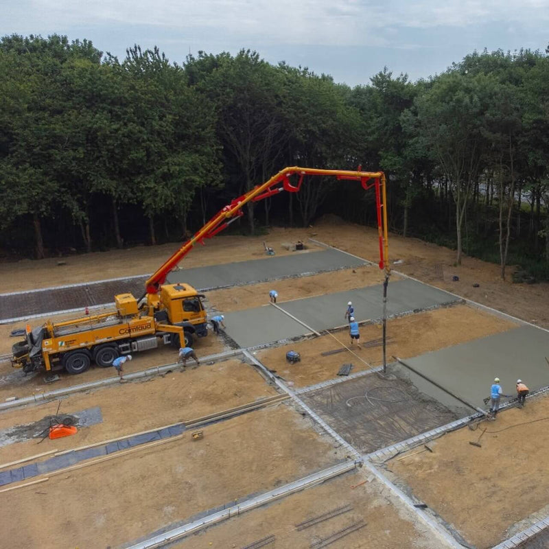 Concrete being poured into K-FORM screed rails for precise and efficient construction projects