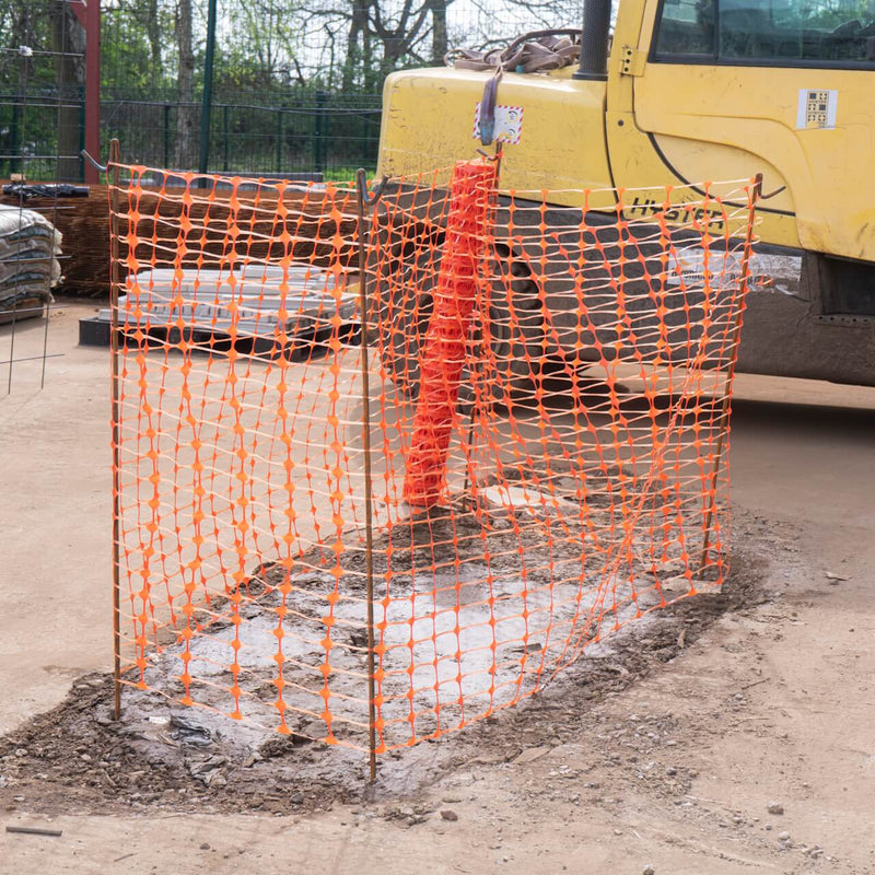 Barrier fencing mesh installed at a construction site to ensure safety and secure the area