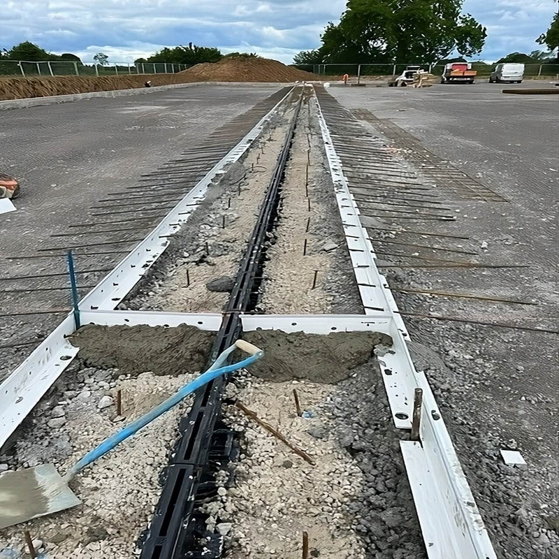 Installation of an integrated drainage system using K-Form in a concrete setup