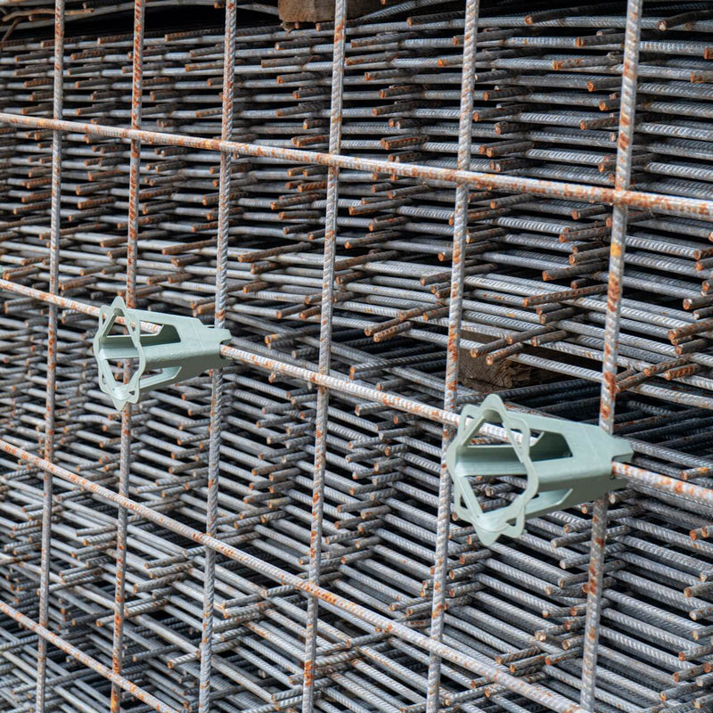 Reinforcement mesh standing upright with durable plastic spacers attached