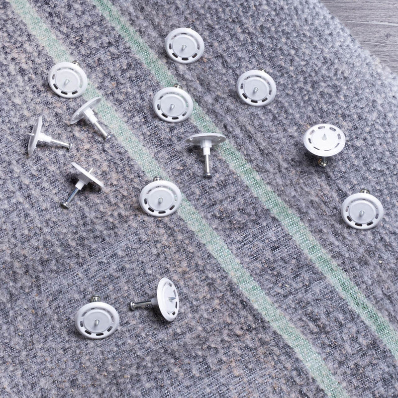 Soft washer fixings displayed on bentonite membranes for secure attachment and protection in waterproofing applications.