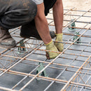 A builder standing on reinforced mesh held firm by Wire High Chair Spacers showcasing durability and support.