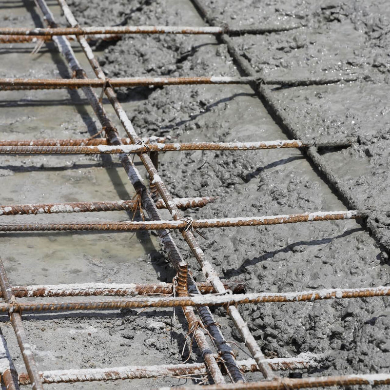 A142 steel mesh reinforcement in place, with concrete pouring in progress