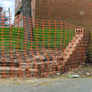 Safety mesh fencing encloses a broken wall during repairs.