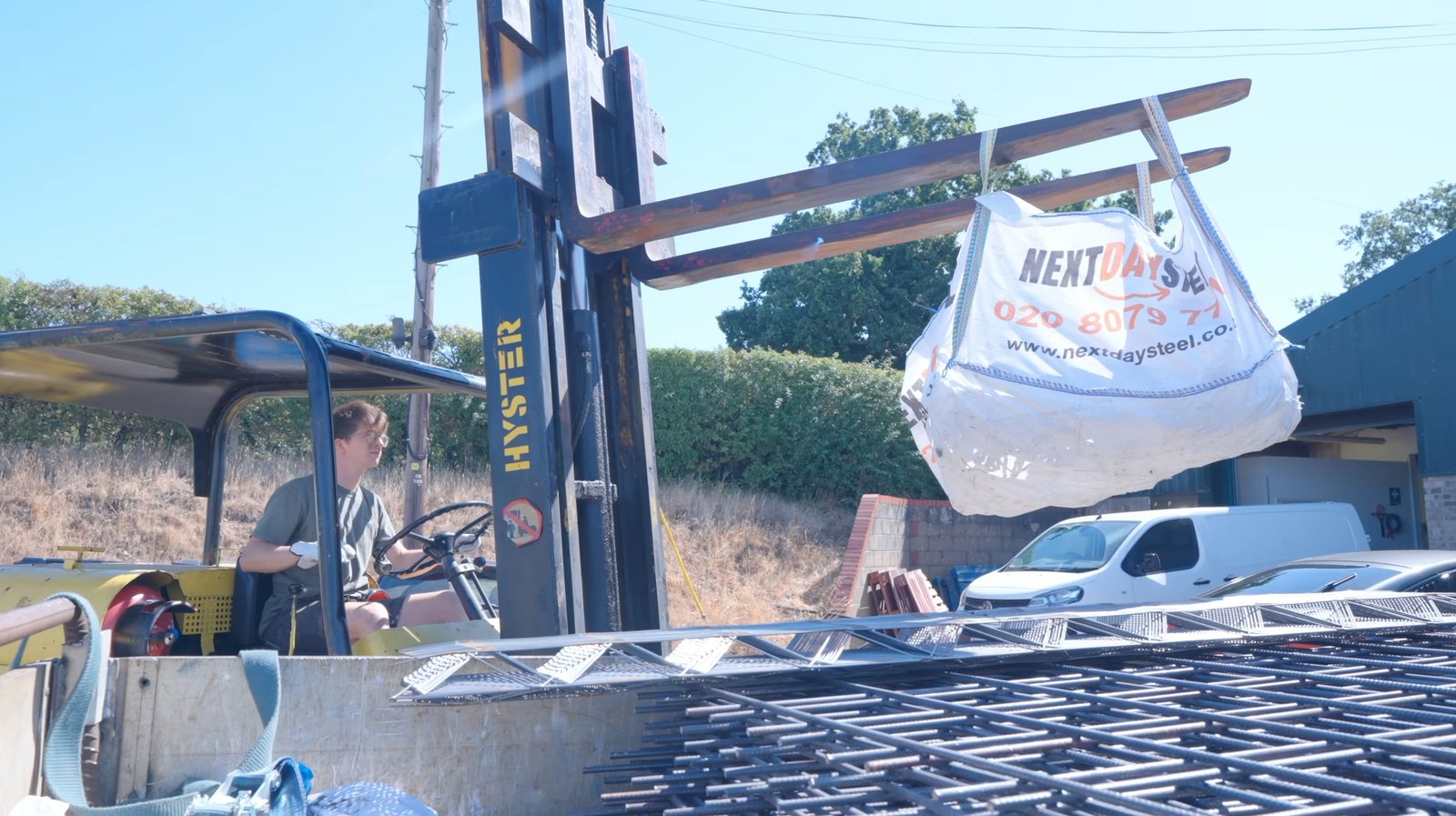 A NextDaySteel branded bulk bag lifted off the delivery lorry by forklift at Alec Steele&rsquo;s workshop